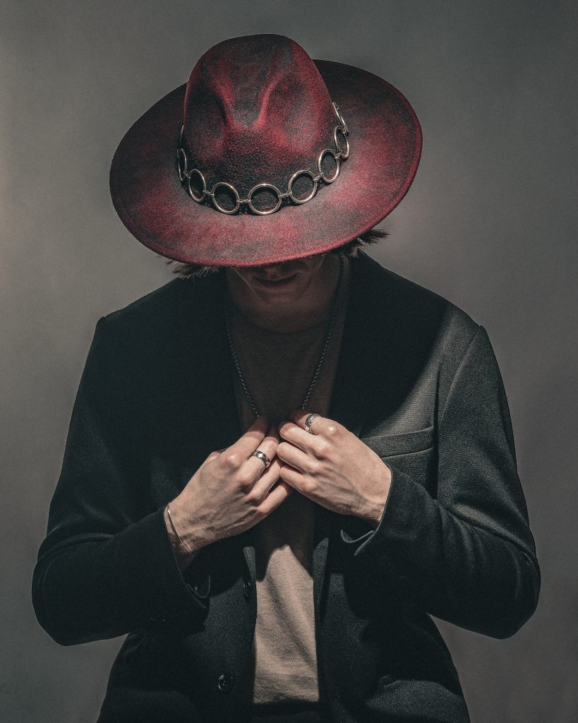 colour photograph of a male actor wearing a cowboy hat