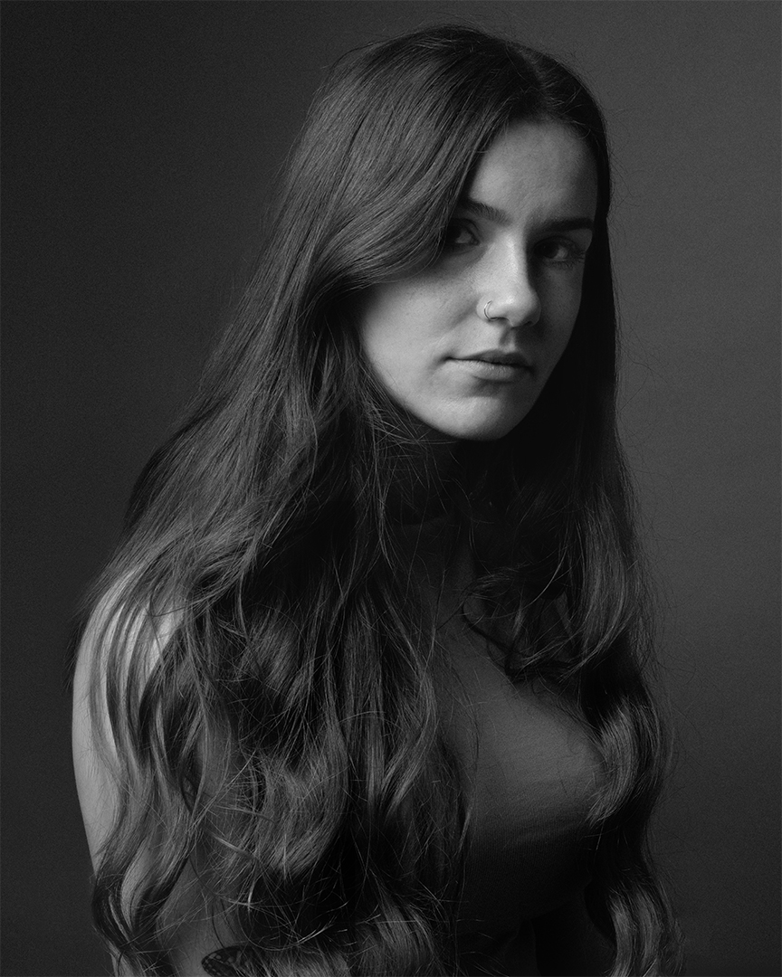 blacn and white portrait of a beautiful woman with very long brunette hair. nikon d750